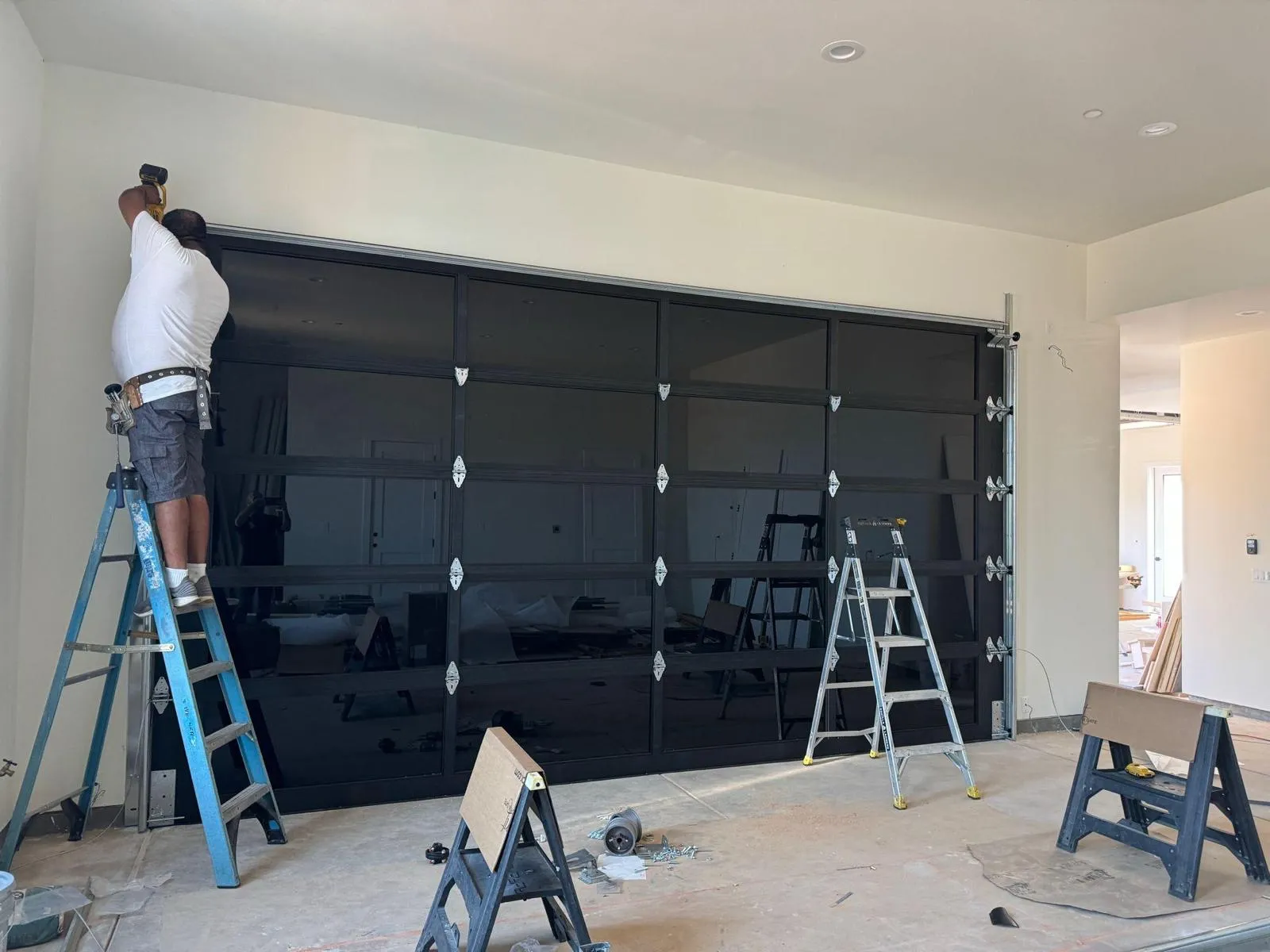 Professional garage door repair technician working on residential garage door