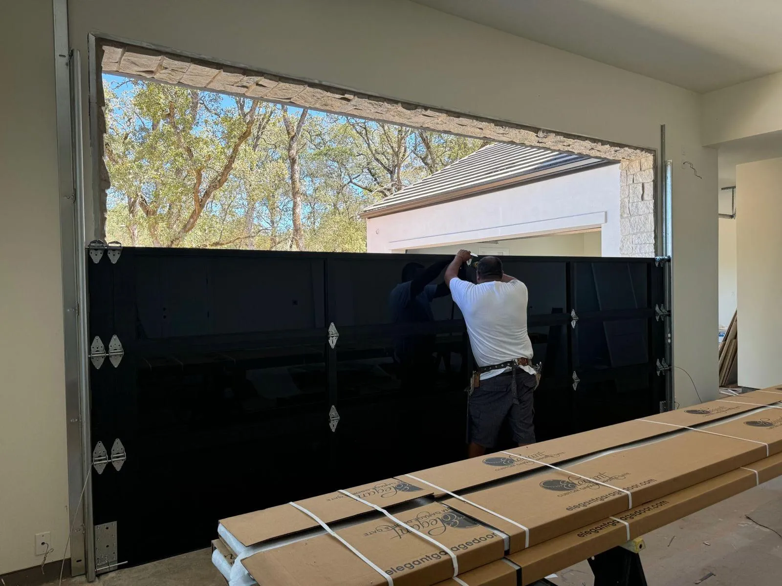 Professional garage door repair technician working on residential garage door