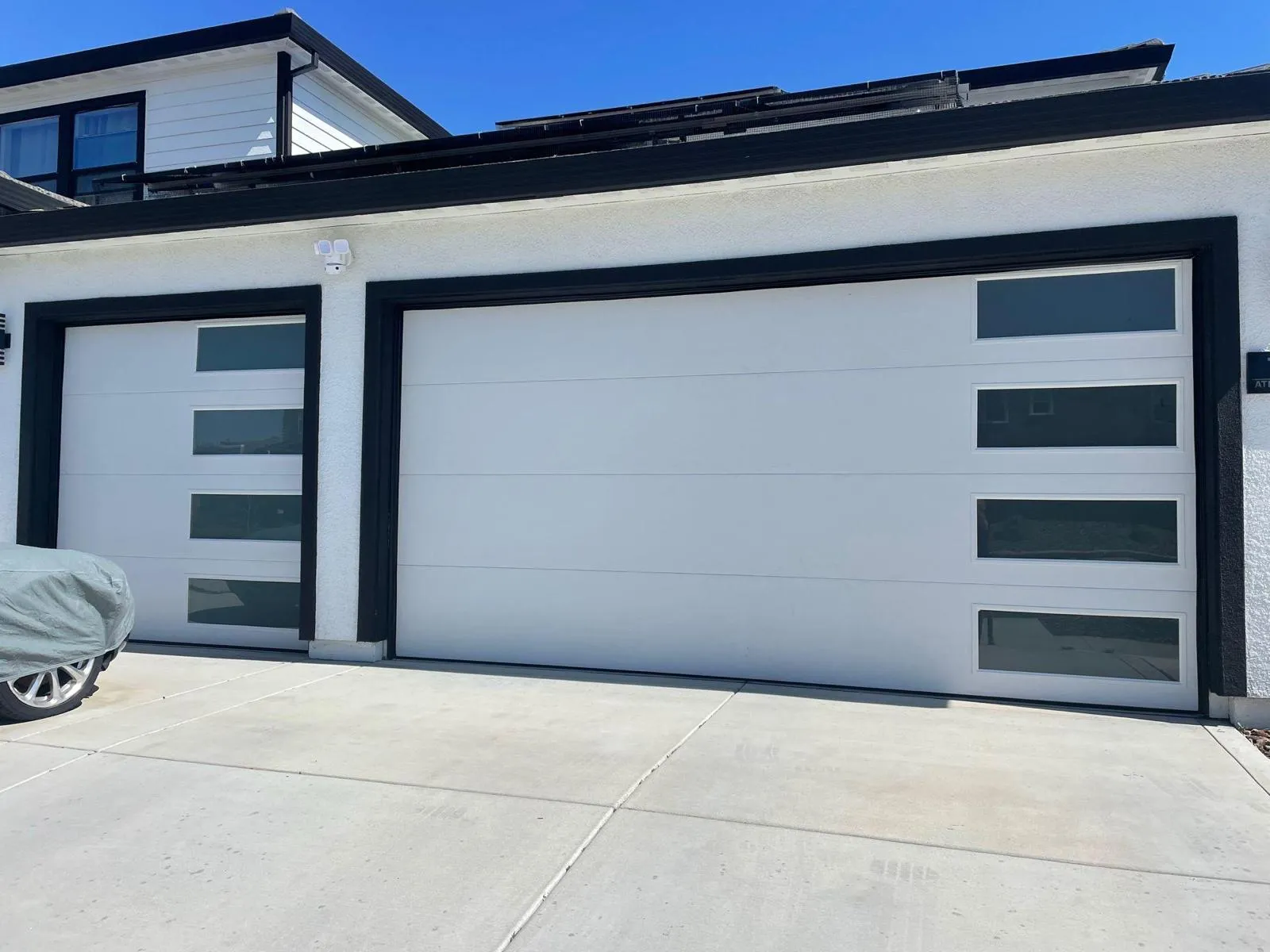 Professional garage door repair technician working on residential garage door