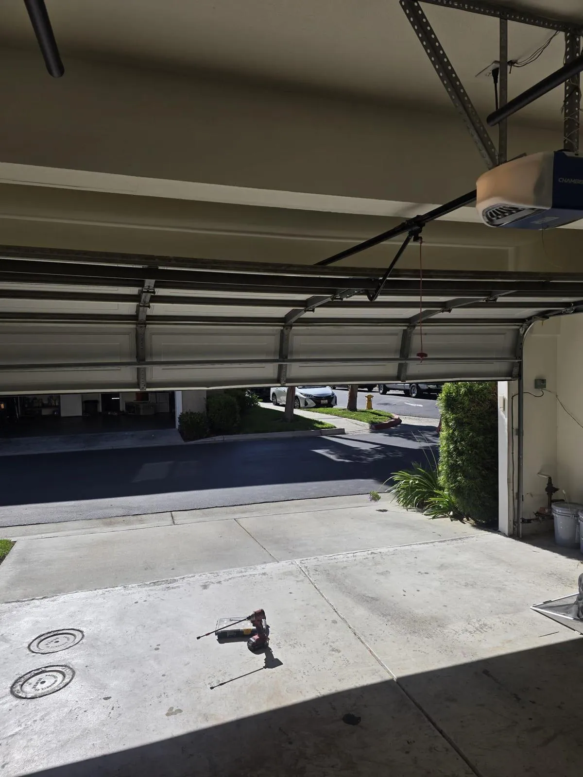 Professional garage door repair technician working on residential garage door